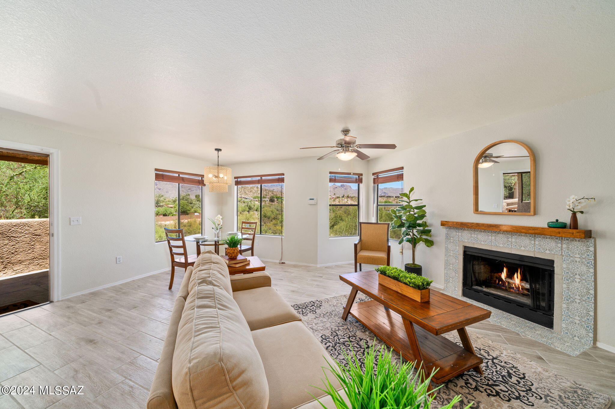 7255 East Snyder Road, Unit 4206 Tucson, AZ 85750 - Photo 1 of 33 a living room with furniture large window and a fireplace