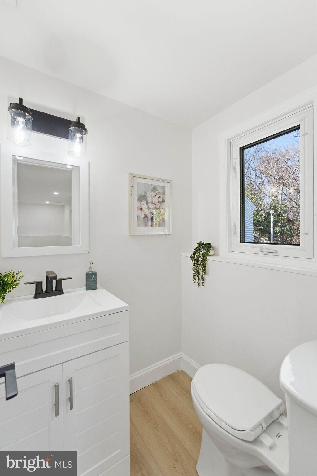 16 Saratoga Road Stratford, NJ 08084 - Photo 22 of 34 a bathroom with a toilet a sink and mirror