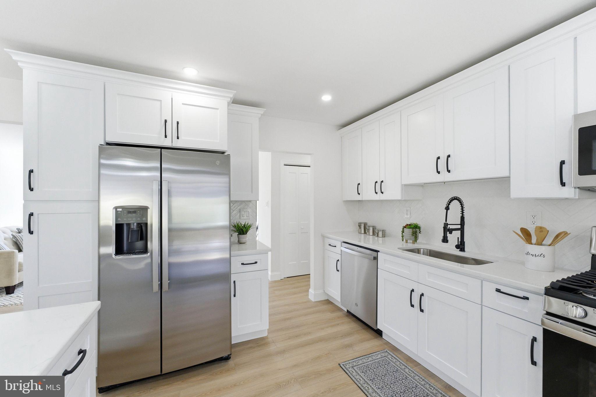 16 Saratoga Road Stratford, NJ 08084 - Photo 10 of 34 a kitchen with stainless steel appliances a refrigerator sink and cabinets