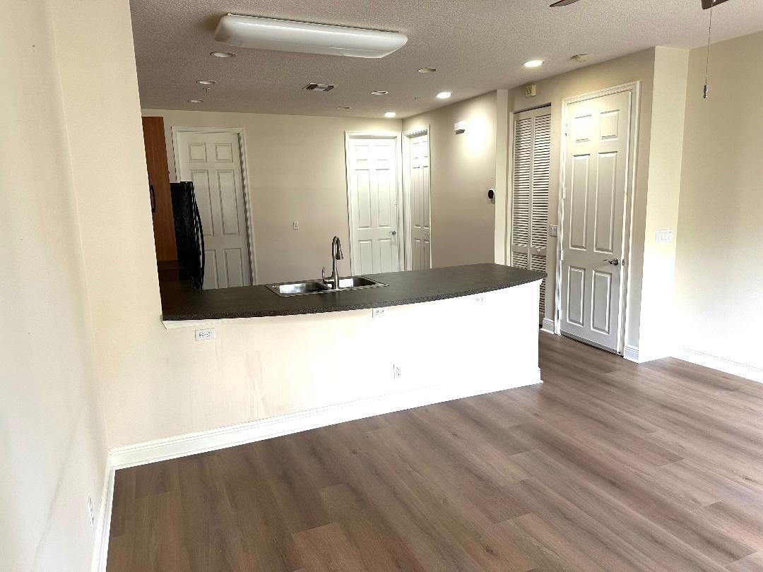 808 University Boulevard Jupiter, FL 33458 - Photo 7 of 16 a large bathroom with a large mirror vanity and shower