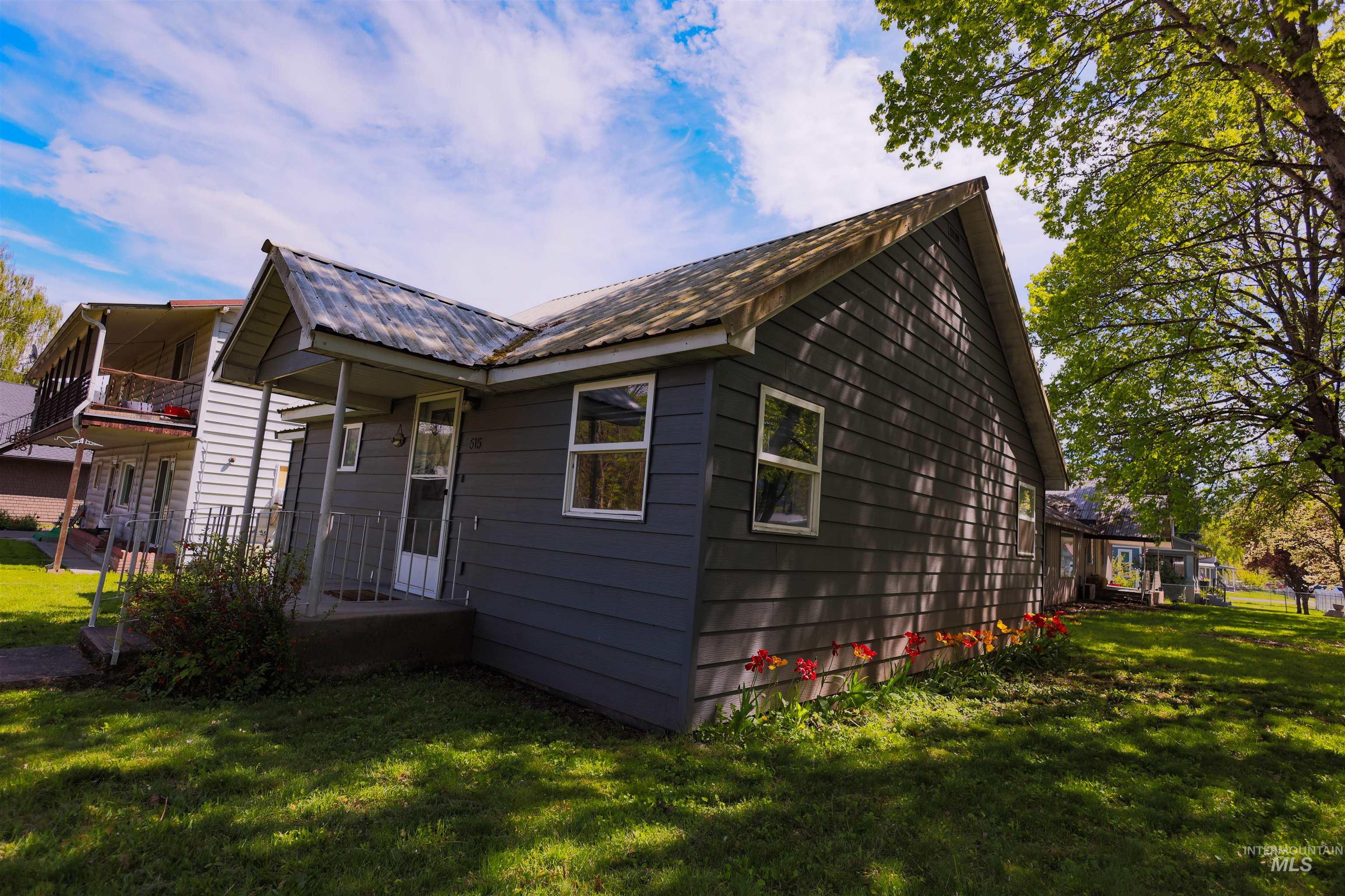515 8th Street Kamiah, ID 83536 - Photo 2 of 31 Gray-painted exterior siding with white trim windows and a covered front entry