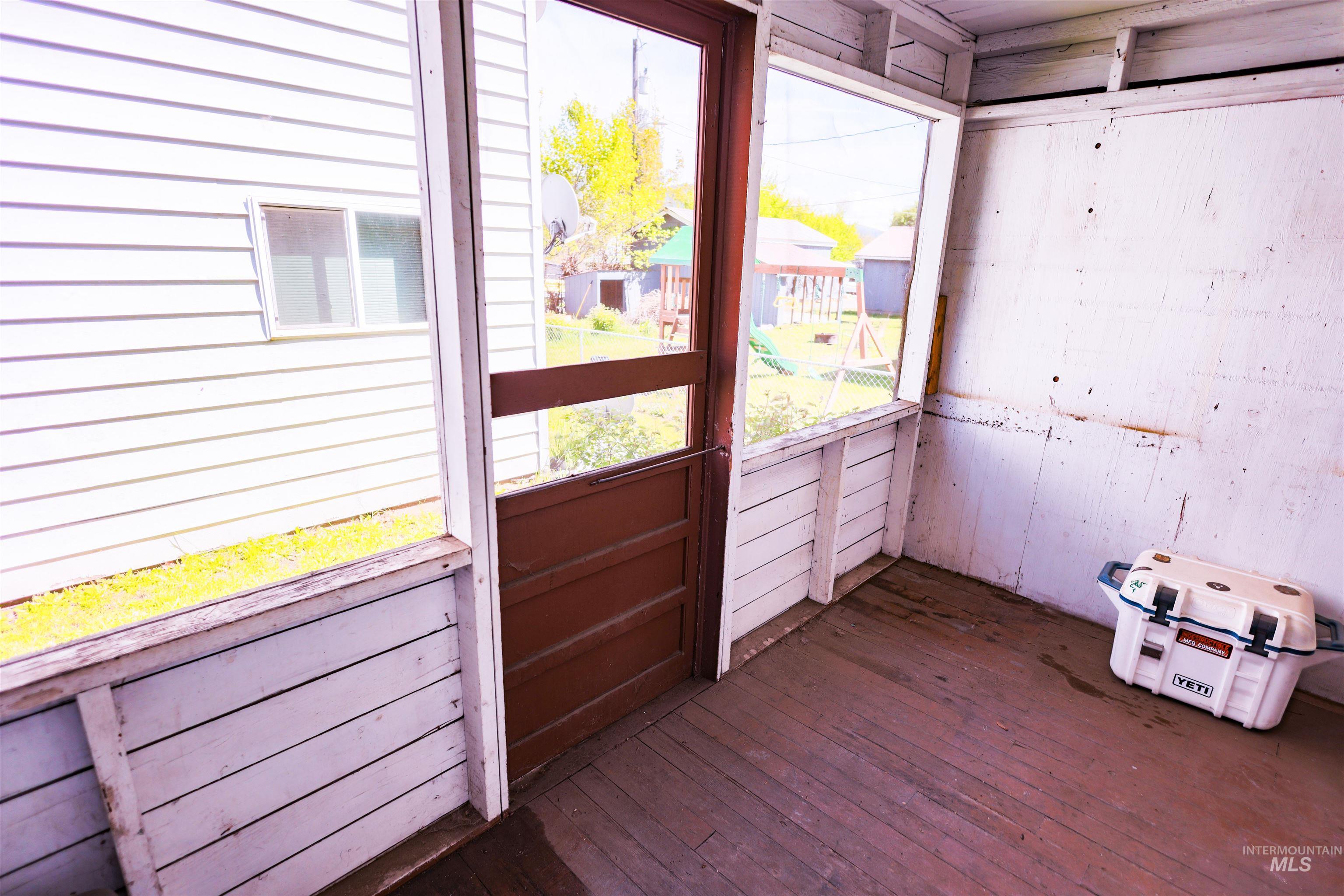 515 8th Street Kamiah, ID 83536 - Photo 25 of 31 Screened porch with wood-finish flooring and white paneled walls