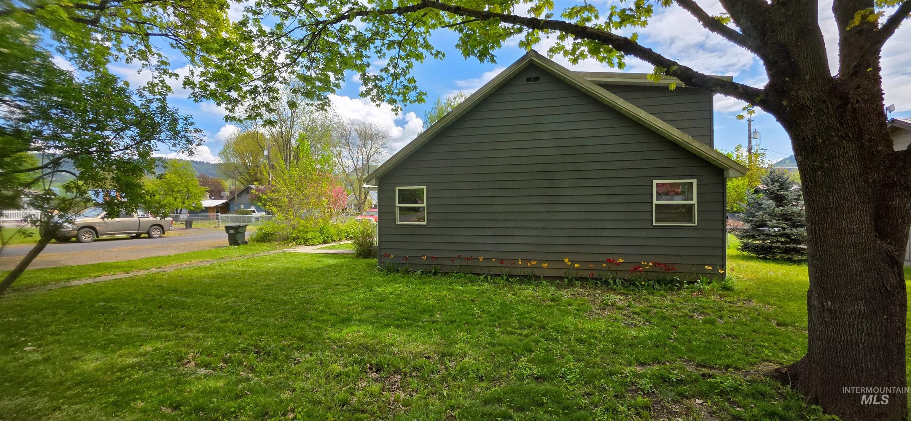 515 8th Street Kamiah, ID 83536 - Photo 5 of 31 Dark green horizontal siding with white window trim and a light green gutter