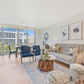 a living room with furniture and a floor to ceiling window