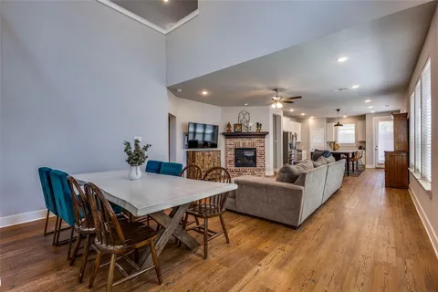 a living room with furniture a table and kitchen view