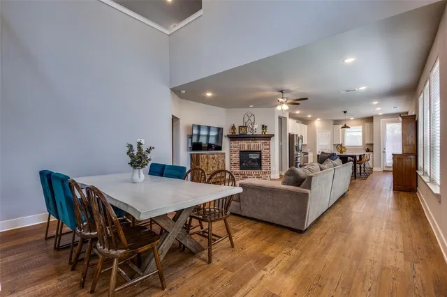 a living room with furniture a table and kitchen view
