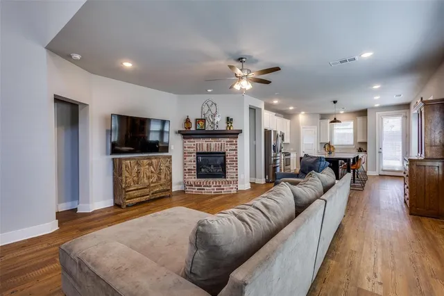 a living room with furniture flat screen tv and a fireplace