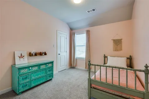 a spacious bedroom with a bed and a dresser