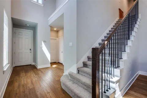 a view of entryway and hall with wooden floor