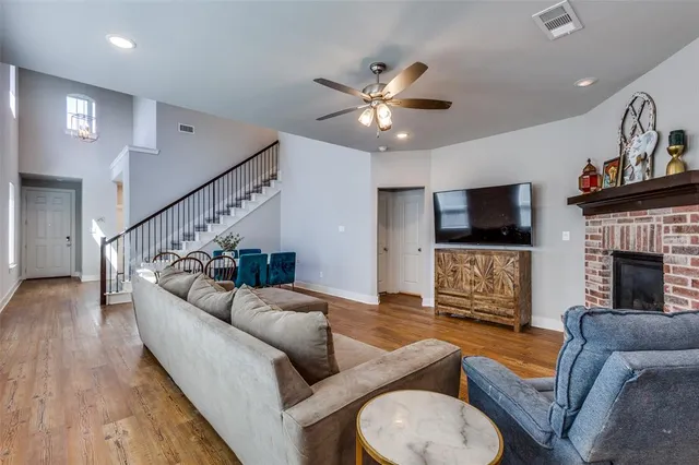 a living room with fireplace furniture and a flat screen tv