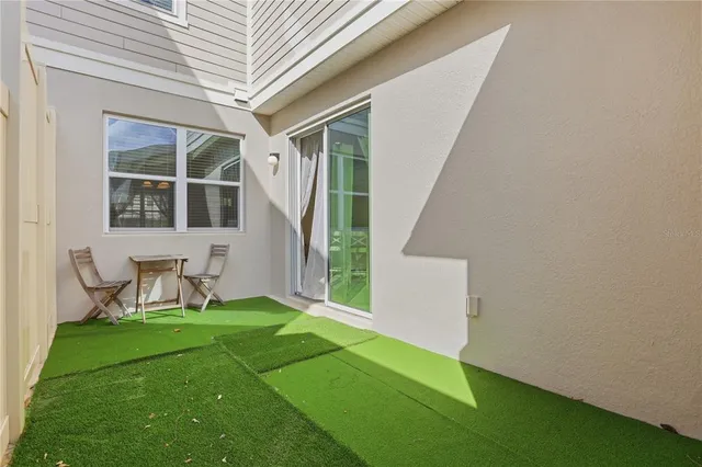a view of an house with backyard porch and sitting area