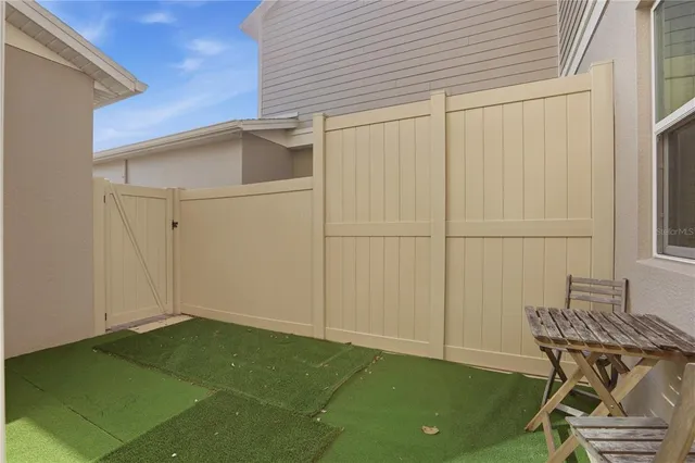 a view of a backyard with chair and table
