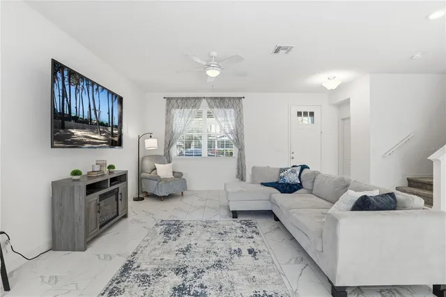 a living room with furniture wooden floor and a flat screen tv