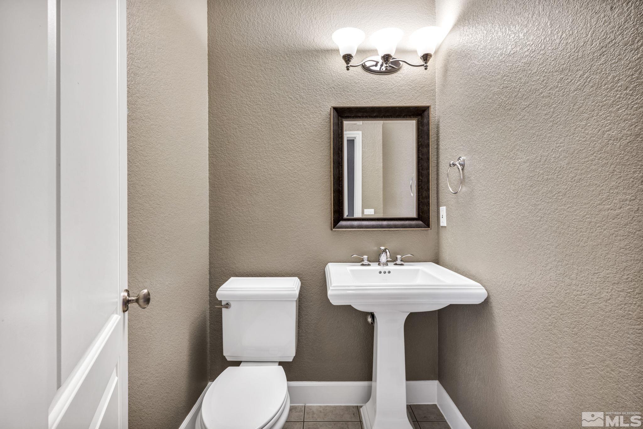 8210 Willow Ranch Trail Reno, NV 89523 - Photo 14 of 38 a bathroom with a sink a toilet and mirror