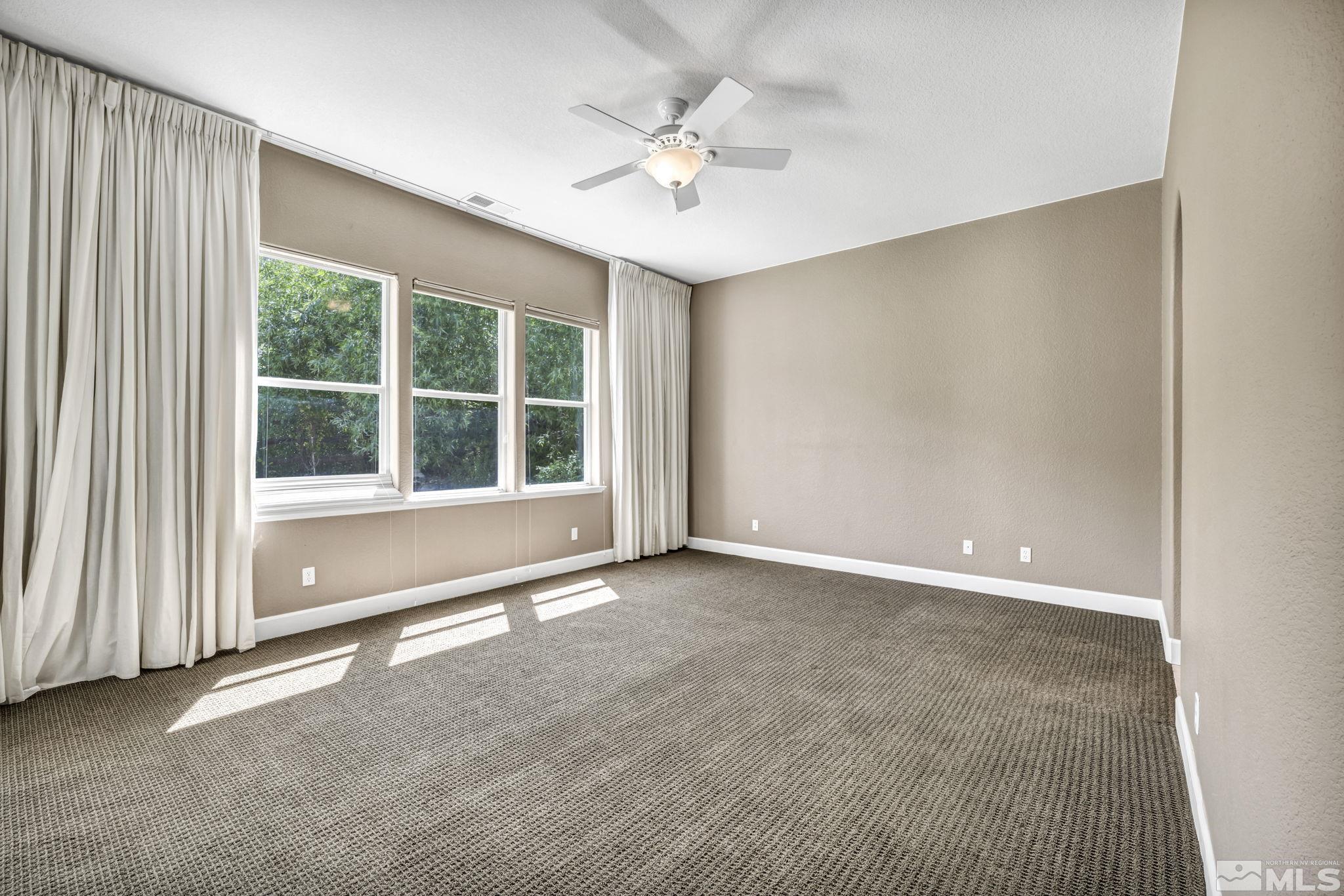 8210 Willow Ranch Trail Reno, NV 89523 - Photo 16 of 38 an empty room with windows and ceiling fan