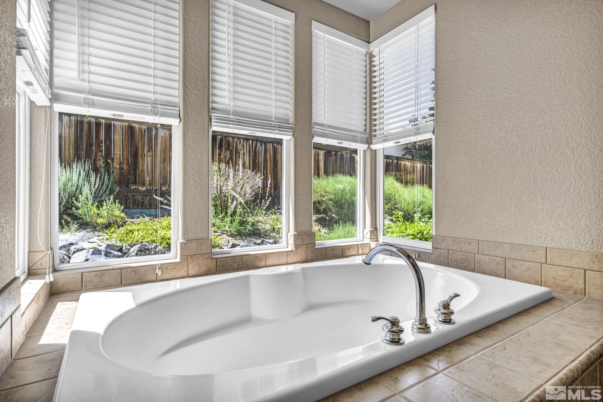 8210 Willow Ranch Trail Reno, NV 89523 - Photo 19 of 38 a bath tub sitting in front of a window