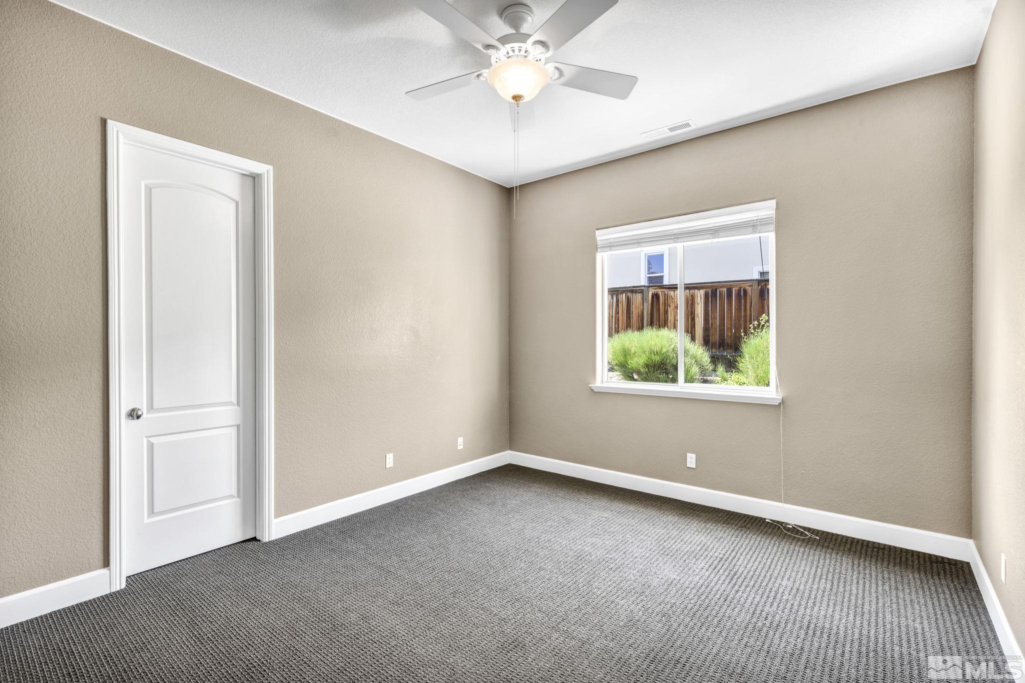8210 Willow Ranch Trail Reno, NV 89523 - Photo 23 of 38 an empty room with a window and a ceiling fan