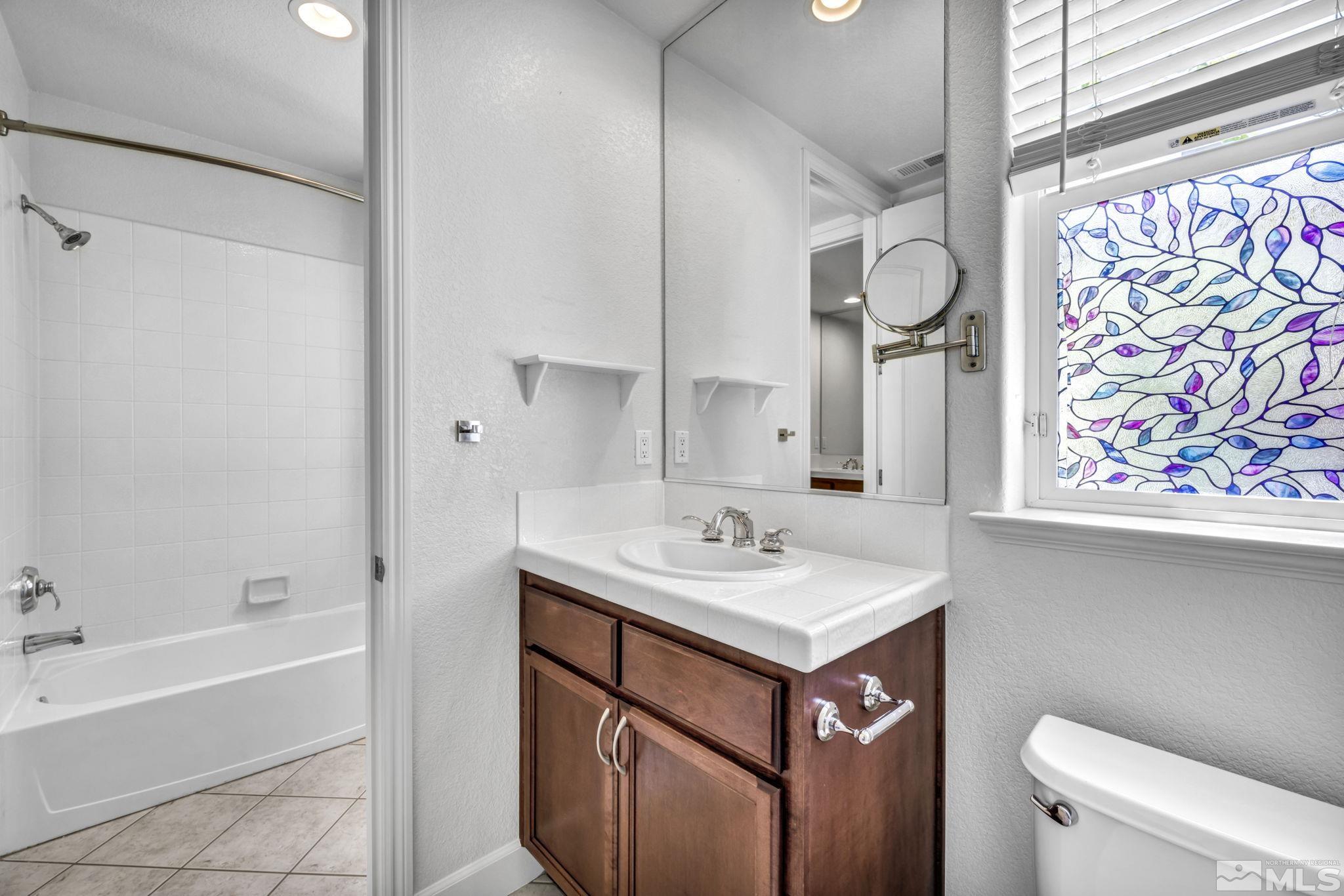 8210 Willow Ranch Trail Reno, NV 89523 - Photo 25 of 38 a bathroom with a sink a toilet and a bathtub