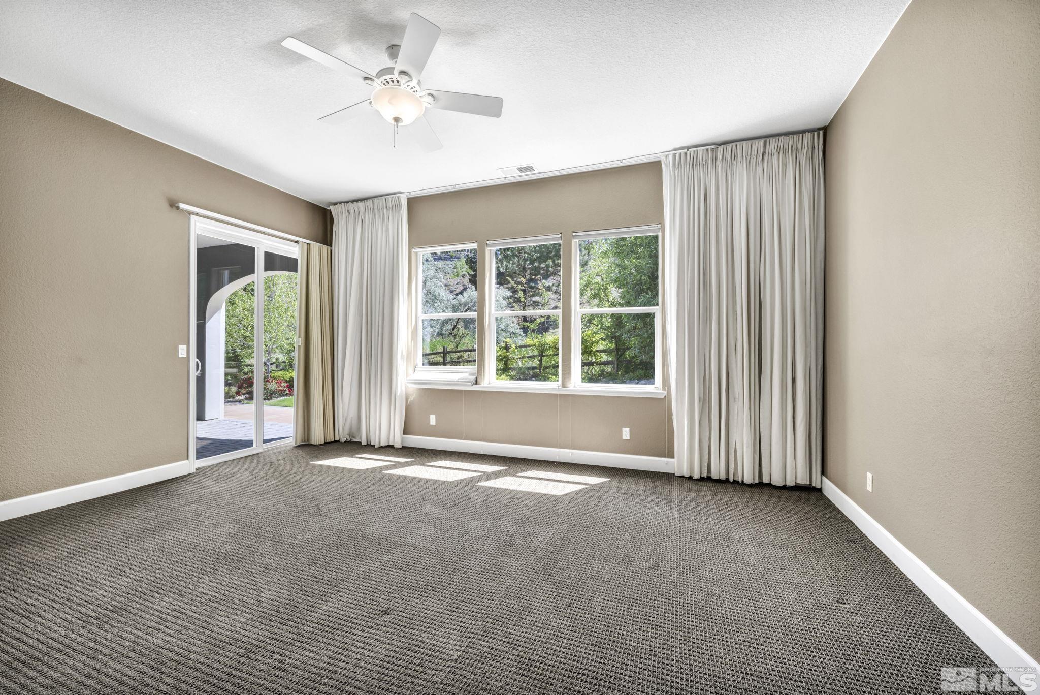 8210 Willow Ranch Trail Reno, NV 89523 - Photo 27 of 38 an empty room with windows and ceiling fan