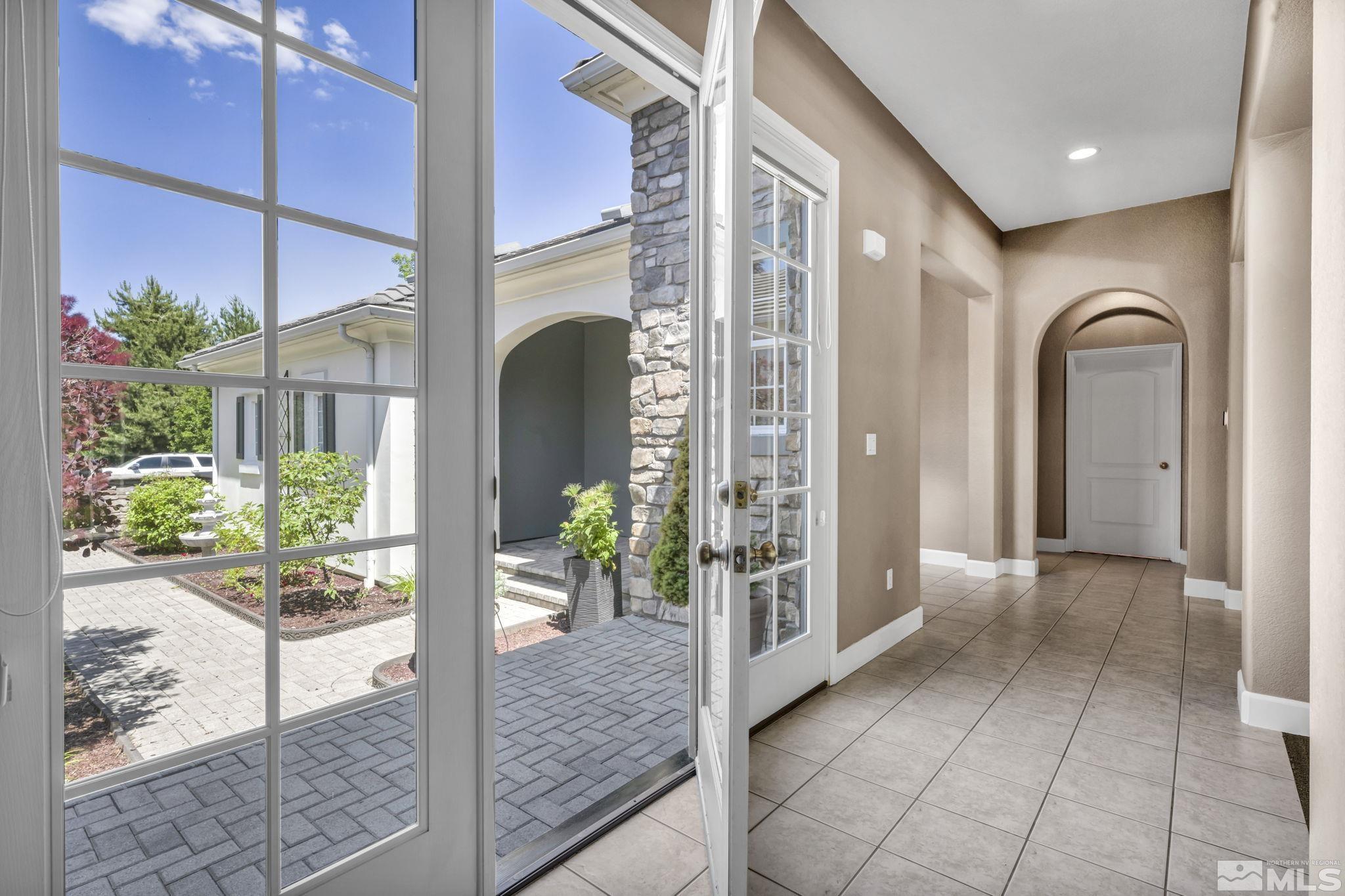 8210 Willow Ranch Trail Reno, NV 89523 - Photo 5 of 38 a view of entryway with a floor to ceiling window and potted plants