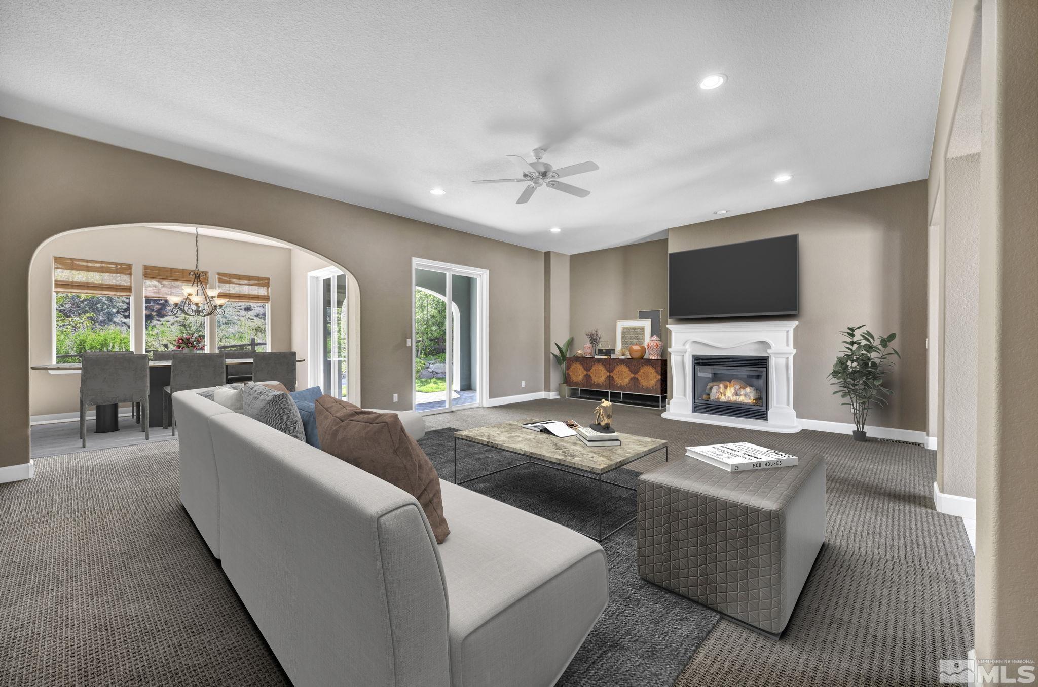 8210 Willow Ranch Trail Reno, NV 89523 - Photo 7 of 38 a living room with furniture a fireplace and a large window