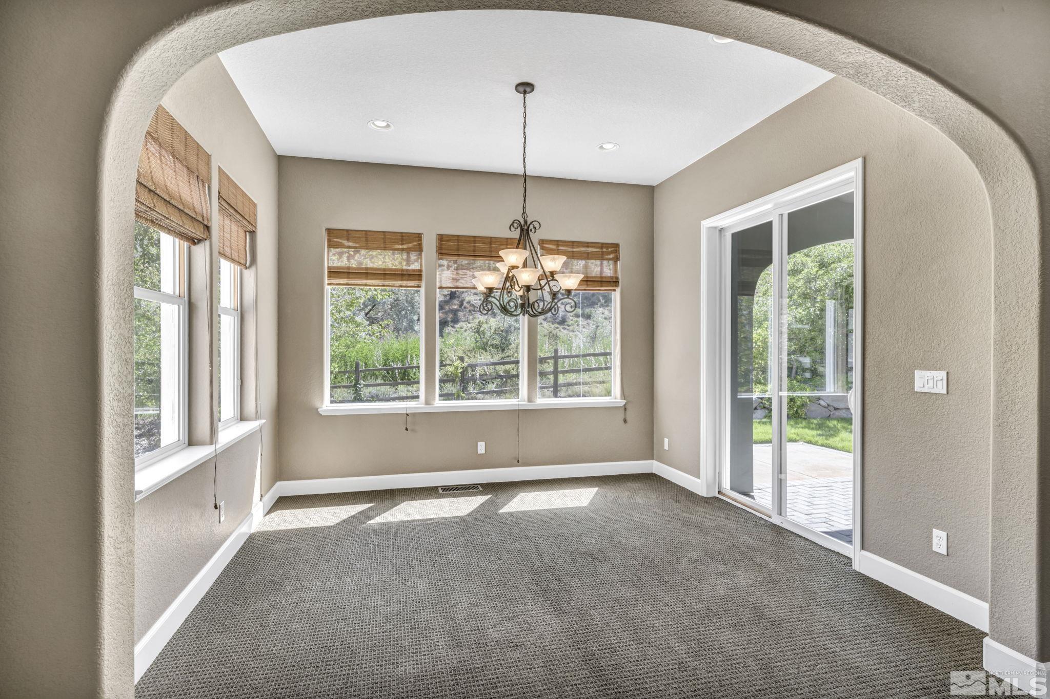 8210 Willow Ranch Trail Reno, NV 89523 - Photo 10 of 38 a view of an empty room with windows and outdoor view