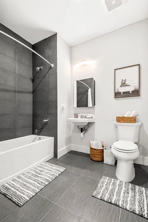 a bathroom with a toilet a sink and bathtub