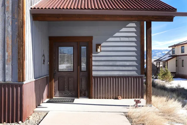 a view of a house with a wooden fence