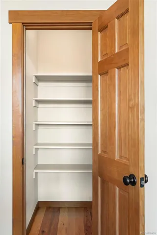 a view of walk in closet with empty racks