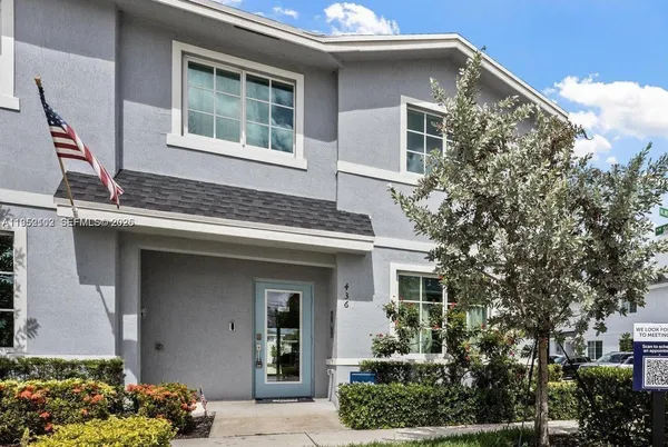 a front view of a house with a garden