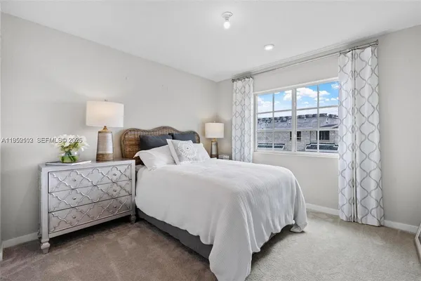 a bathroom with a bathtub shower sink vanity mirror and toilet