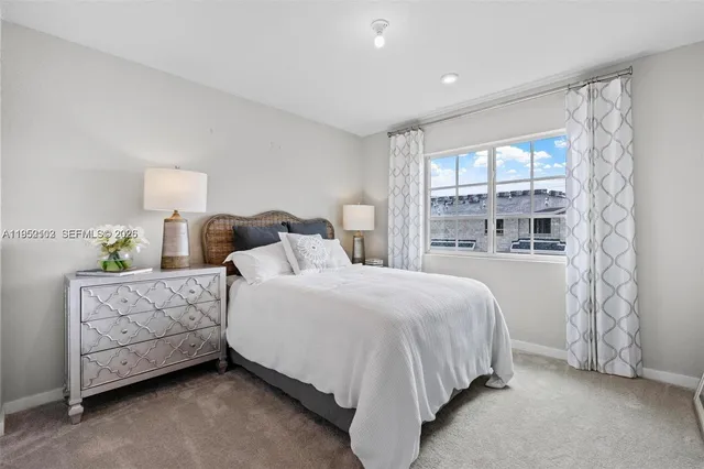 a bathroom with a bathtub shower sink vanity mirror and toilet