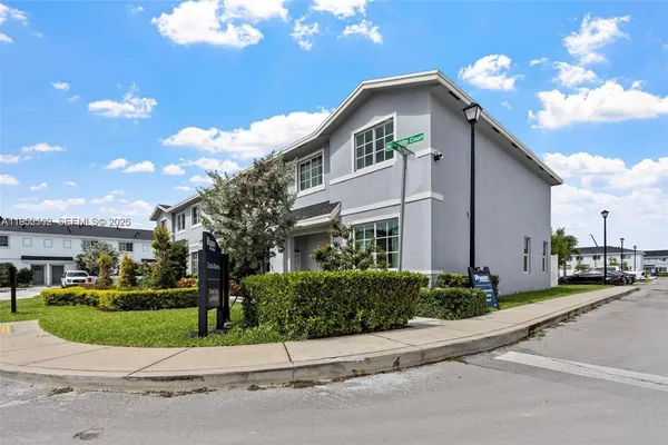 a view of a house with backyard sitting area and garden