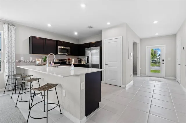 a kitchen with stainless steel appliances a refrigerator and a stove top oven