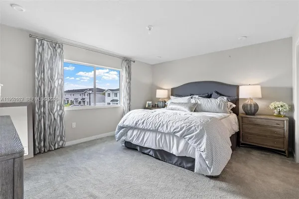 a spacious bedroom with a bed and a window
