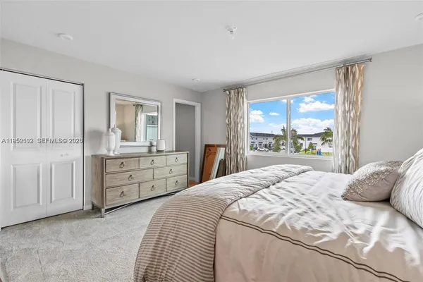 a bedroom with a large bed and a dresser