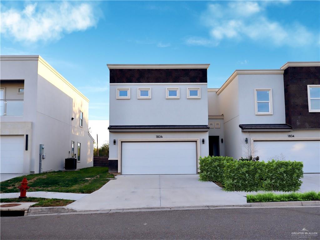 1836 Sunset Drive Mission, TX 78572 - Photo 1 of 24 a front view of a house with a yard and garage