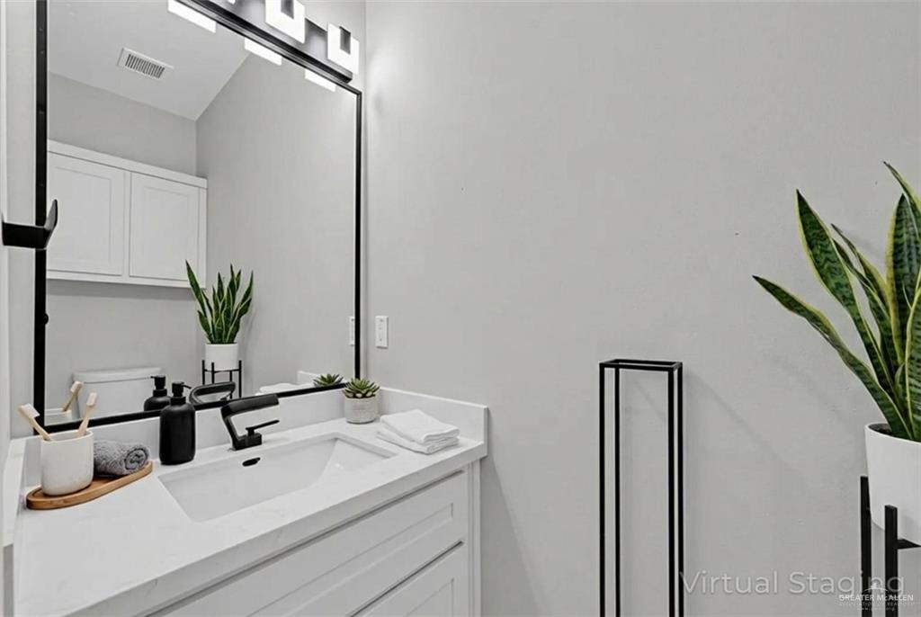 1836 Sunset Drive Mission, TX 78572 - Photo 12 of 24 a bathroom with a sink and a mirror