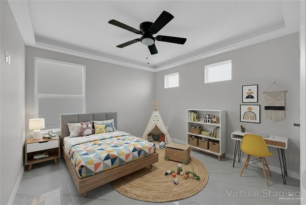 1836 Sunset Drive Mission, TX 78572 - Photo 19 of 24 a bedroom with a bed a couch and a chandelier