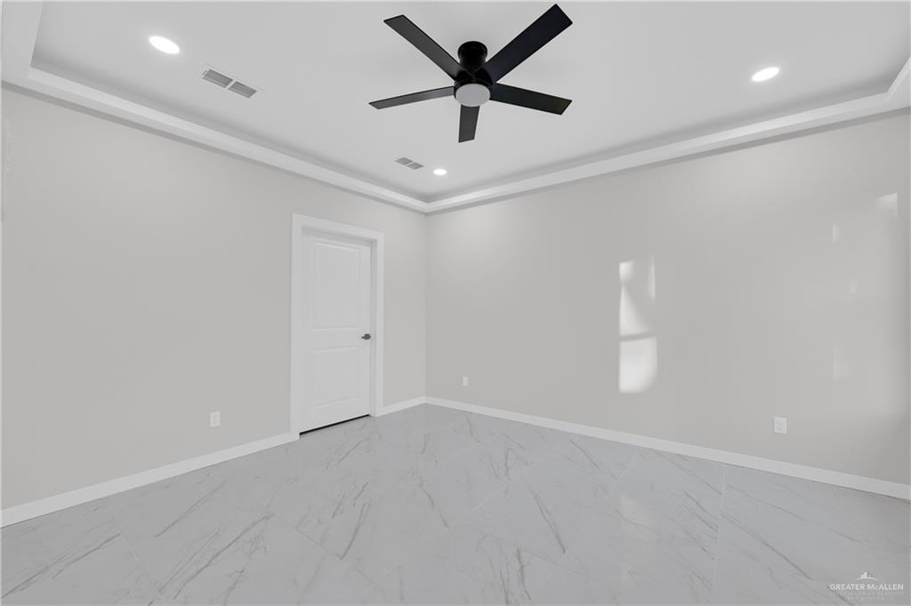 1836 Sunset Drive Mission, TX 78572 - Photo 8 of 24 an empty room with a ceiling fan and a ceiling fan