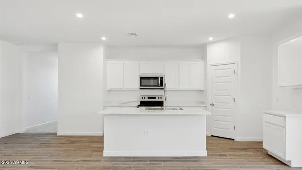 a kitchen with stainless steel appliances a white stove top oven and a refrigerator