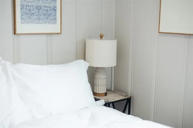 a bedroom with a bed and a table in it