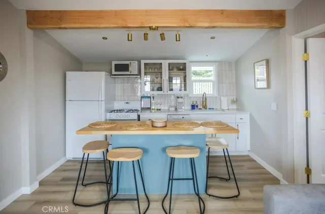 a kitchen with granite countertop a refrigerator and a stove