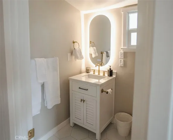 a bathroom with a double vanity sink mirror and toilet