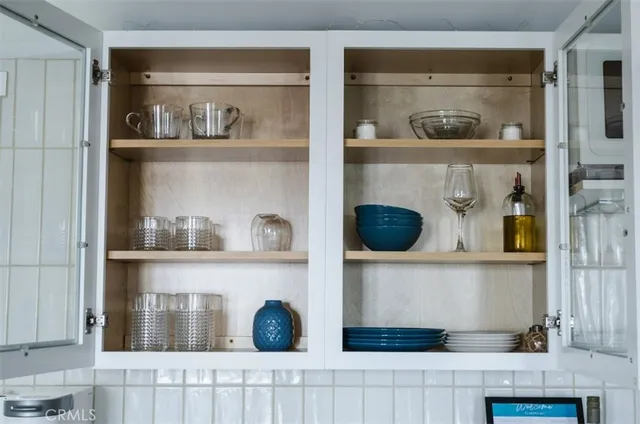 a shelf with cup and plates