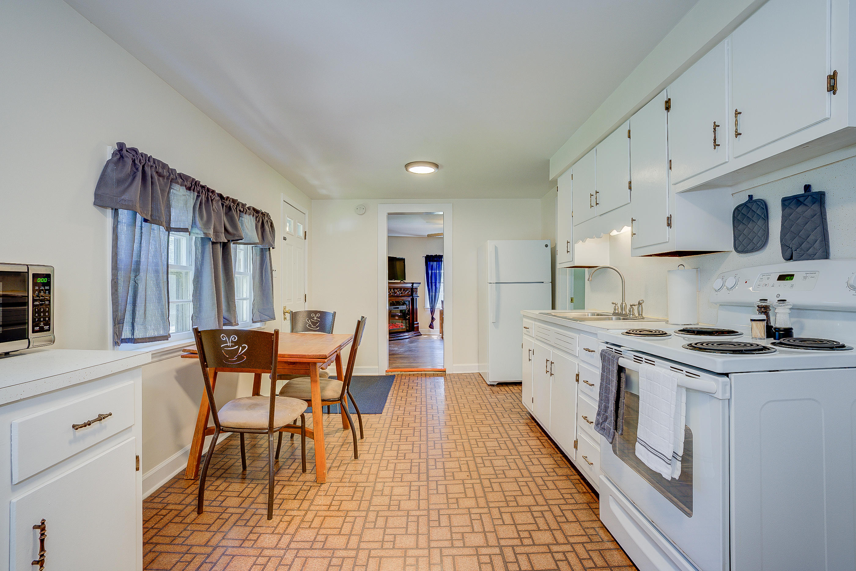 6150 Hardy Road Hardy, VA 24101 - Photo 5 of 17 a kitchen with stainless steel appliances granite countertop a stove a sink dishwasher and a refrigerator with white cabinets