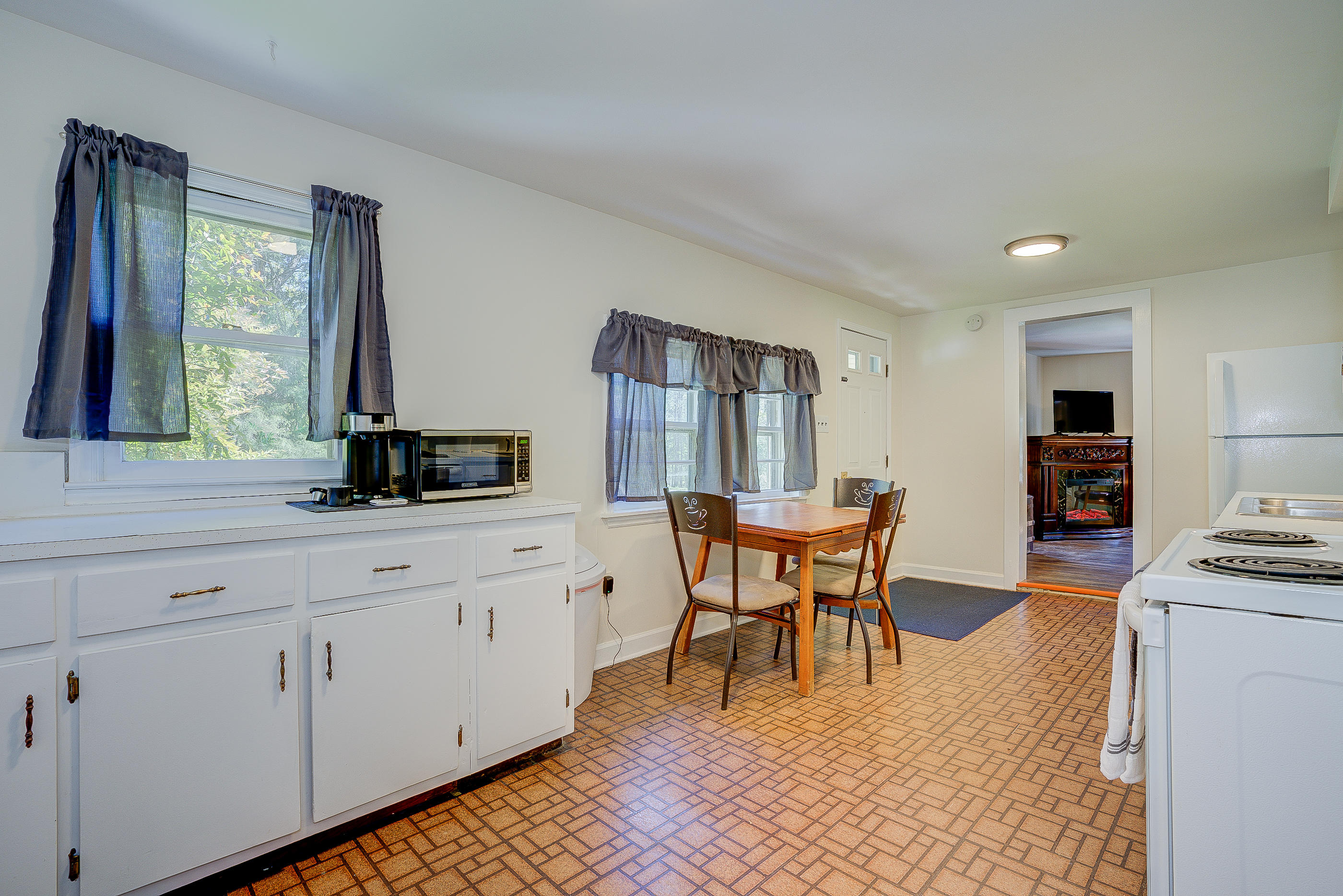 6150 Hardy Road Hardy, VA 24101 - Photo 8 of 17 a kitchen with stainless steel appliances kitchen island granite countertop a sink a stove a dining table and chairs with wooden floor