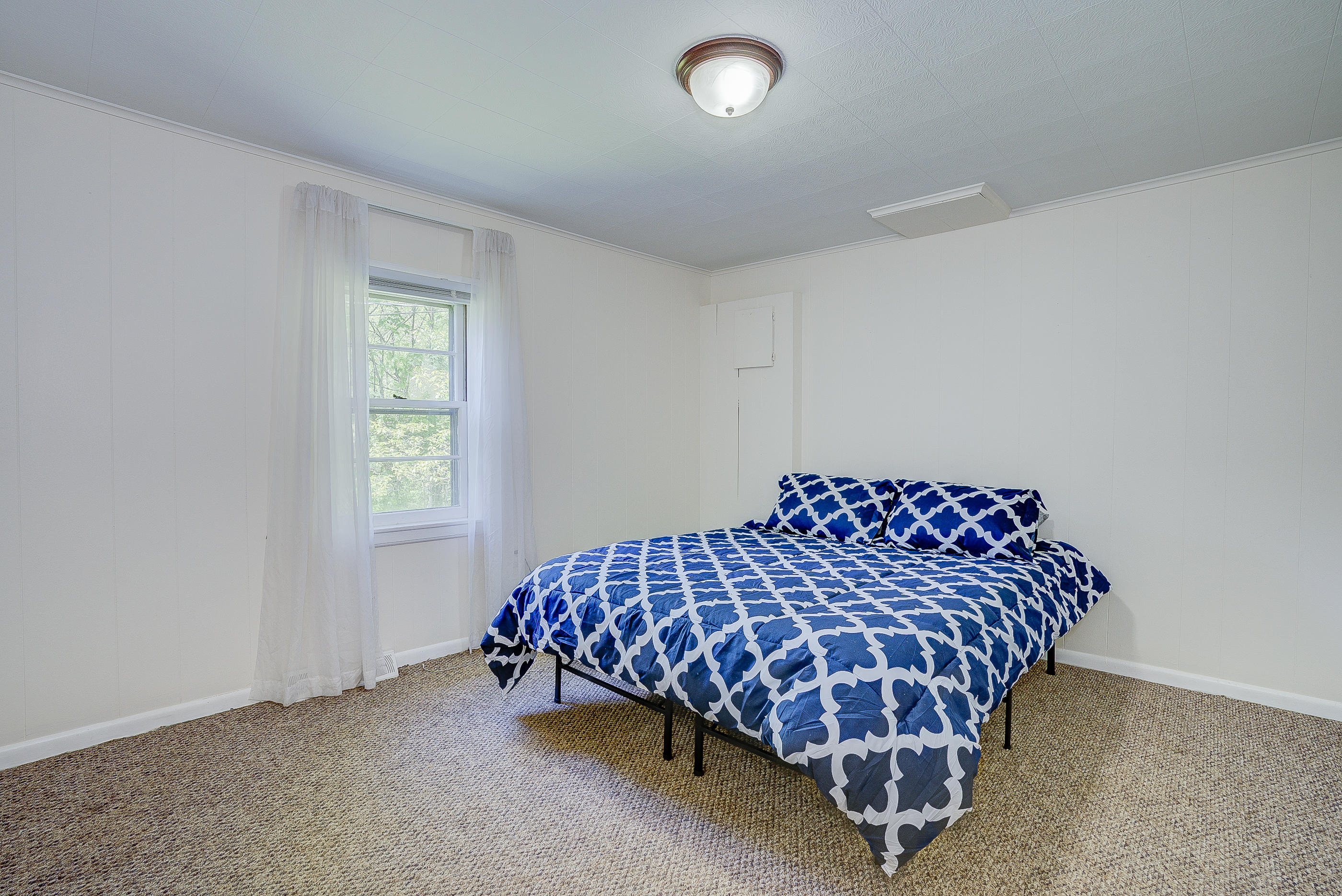6150 Hardy Road Hardy, VA 24101 - Photo 10 of 17 a bed sitting in a bedroom next to a window