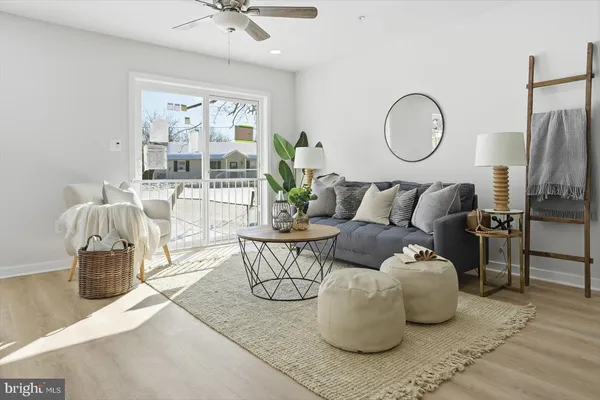 a living room with furniture a fireplace and a chandelier