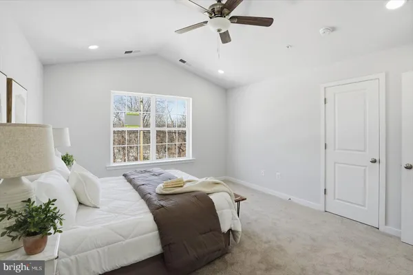 a spacious bedroom with a bed and a window